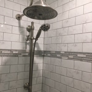 Daltile porcelain tile and Delta shower set